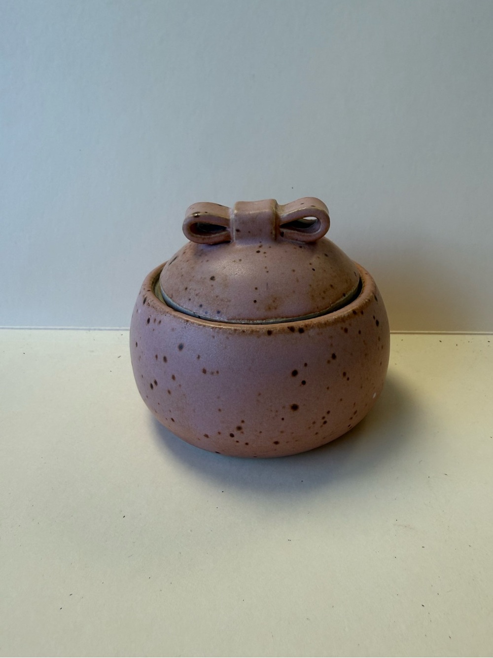 Handcrafted Speckled Mauve Ceramic Lidded Jar with Bow Accent & Green Inside.